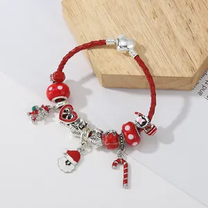 Christmas charm bracelet with Santa Claus and candy cane charms on red leather rope