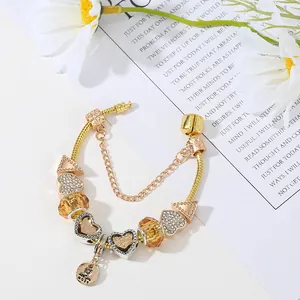 Gold snake chain bracelet with sparkling heart charms and amber glass beads