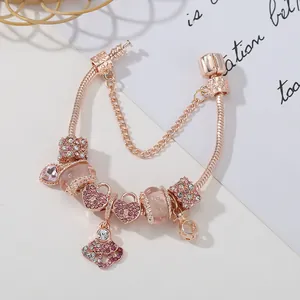 Rose gold snake chain charm bracelet with pink crystals and heart crown pendants