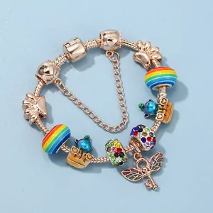Rose gold snake chain bracelet with rainbow beads and winged key charms for women