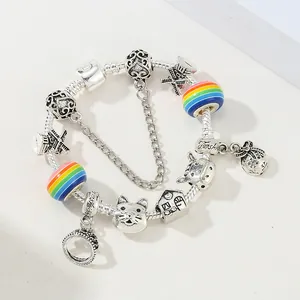 DIY colorful beaded crown bracelet with rainbow charms and safety chain on white background