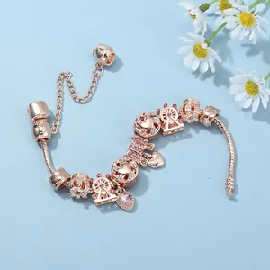 Rose gold ferris wheel charm bracelet with pink crystal heart and crown pendants