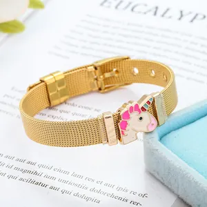 Detail of a 10mm gold mesh bracelet with a pink and white enamel unicorn charm for kids