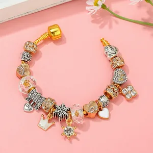 Classic charm bracelet with gold crown, heart charms and snowflakes on snake chain
