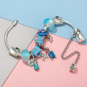 S925 silver travel charm bracelet with suitcase and airplane pendants on blue background