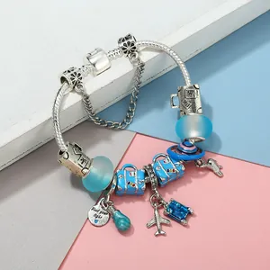 Classic silver snake chain bracelet with blue travel charms and light bulb pendant