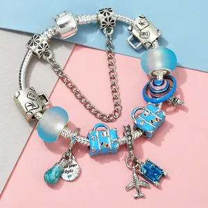 Silver snake chain bracelet with blue enamel travel charms and motivational pendant
