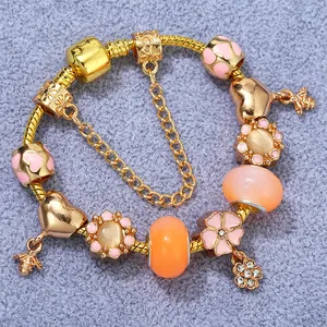 Pink floral charm bracelet with bee pendant and gold snake chain for a romantic look