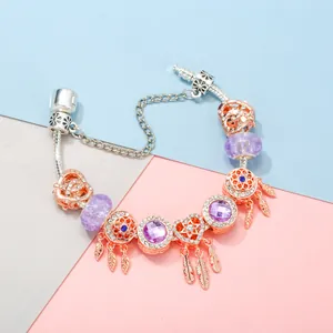 Bracelet maille serpent en or rose avec cristaux violets et breloques attrape-rêves