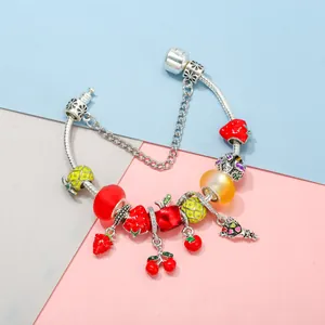 DIY charm bracelet with colorful enamel fruit charms such as strawberry and pineapple
