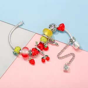 DIY charm bracelet with silver snake chain and colorful enamel fruit pendants like pineapple