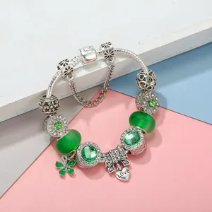 Silver snake chain bracelet with green faceted beads and a heart Love pendant
