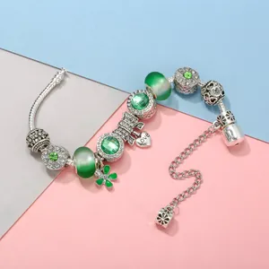 Forest style silver snake chain bracelet with green glass beads and heart charm