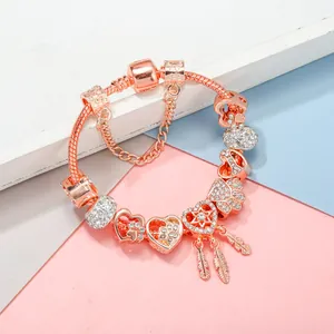 Rose gold dreamcatcher charm bracelet with crystal heart charms and snake chain