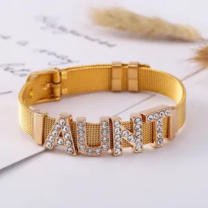 Macro detail of golden mesh bracelet with rhinestone AUNT lettering and buckle