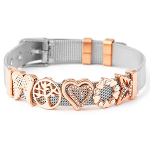 Detail of silver mesh bracelet featuring rose gold angel wings and heart charms