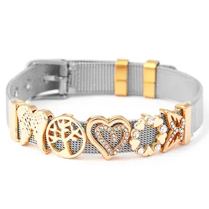 Detail of silver mesh bracelet with golden tree of life and heart charms and watch strap buckle