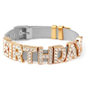 Detailed macro view of the silver mesh strap with sparkling BIRTHDAY crystal charms