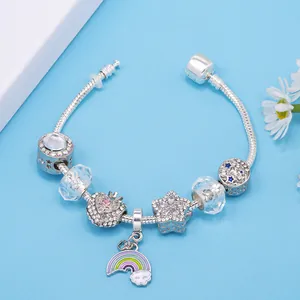 Silver beaded snake chain bracelet with crystal charms and blue star pendants on blue background