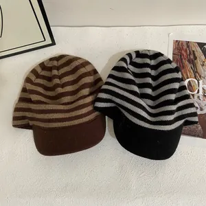 Minimalist striped knit peaked caps in brown and grey with soft warm texture