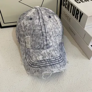 Retro distressed washed denim baseball cap with blue snowflake bleach pattern and ripped holes