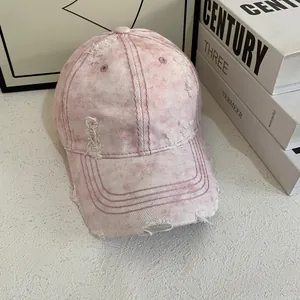 Distressed pink washed cotton baseball cap with retro frayed holes and street style