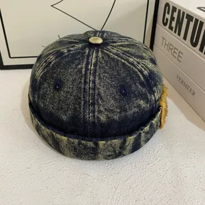 Detail of vintage washed denim docker hat with yellow acid wash finish and side eyelets