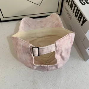 Rear view of pink washed denim cap showing the adjustable metal buckle and distressed detail