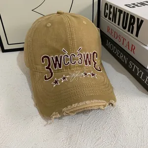 Detail of khaki distressed baseball cap with 3D embroidery and worn brim edge details