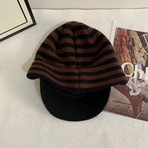 Detailed close-up of the thick brown and black striped knit texture on this warm winter cap