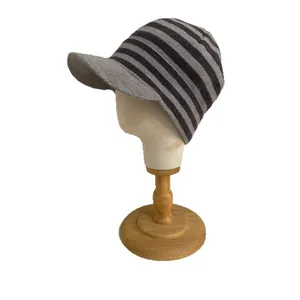 Chic grey and black striped knitted peak cap for women's winter warmth and style