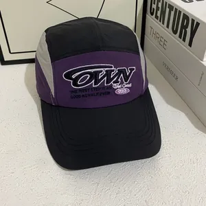 Retro five-panel baseball cap with purple, black, and gray color-blocking and embroidery