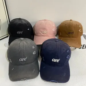Distressed cotton baseball caps with torn details and are² embroidery in five colors