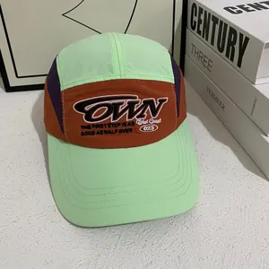 Detailed close-up of color-block nylon baseball cap with white OWN embroidered letters