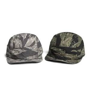 Detail view of two 5-panel camouflage camper caps in tiger stripe patterns and soft canvas