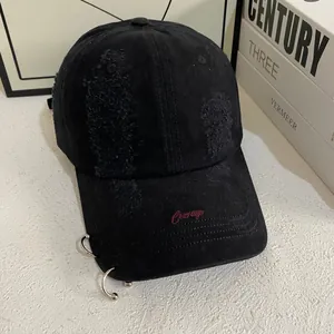 Close-up of distressed cotton baseball cap featuring Courage embroidery and metal rings
