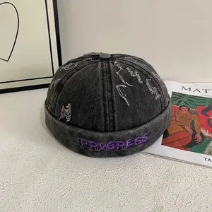 Vintage gray distressed denim docker hat with purple PROGRESS embroidery lettering