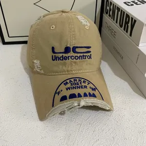 Close-up of distressed cotton baseball cap with blue UC embroidery and vintage finish
