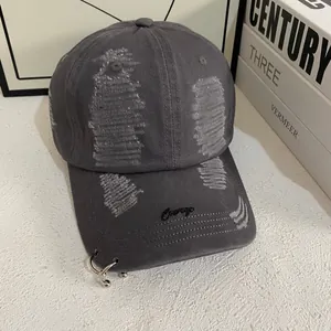 Distressed cotton baseball cap detail with metal rings and Courage embroidery