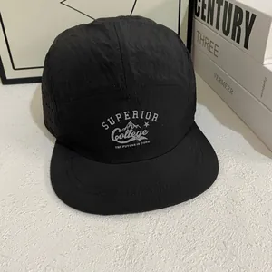 Detail of black five-panel camp hat featuring laser-cut ventilation and vintage print