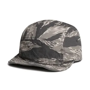 Close-up of tiger stripe camo ripstop fabric and side metal vents on the 5-panel cap