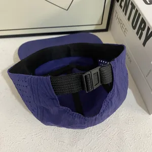 Detail of violet quick-dry sports cap with laser-cut vents and adjustable buckle strap