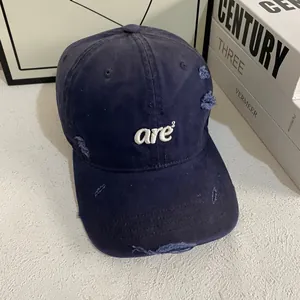 Navy blue distressed baseball cap with white 3D embroidery and vintage ripped details