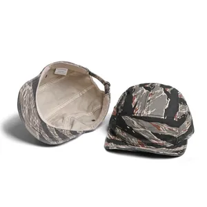 Detail view of cotton camo baseball cap showing 100% cotton wash label and inner stitching