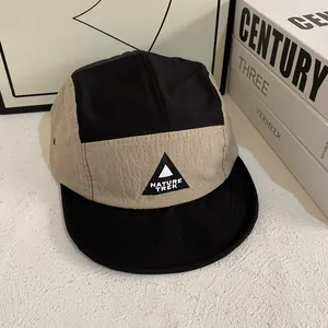 Detail of five-panel camper hat featuring contrast colors and Nature Trek logo