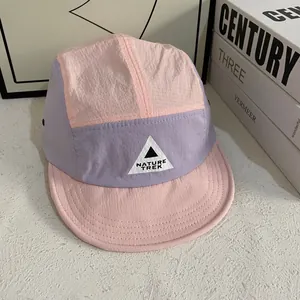 Detail of color-block camper hat showing pink and purple ripstop fabric with Nature Trek logo