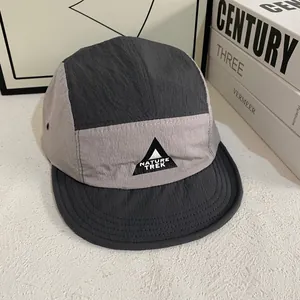 Detail view of quick-dry five-panel camper hat with metal eyelets and Nature Trek logo
