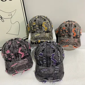 Distressed vintage denim baseball caps with colorful ripped holes and washed cotton finish