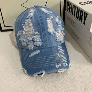 Vintage washed light blue denim baseball cap with distressed ripped details for women