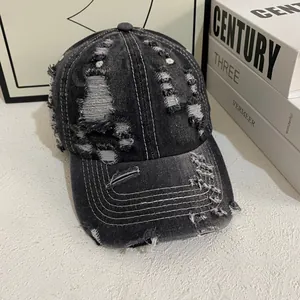 Retro distressed dark gray denim baseball cap with vintage frayed holes and worn texture